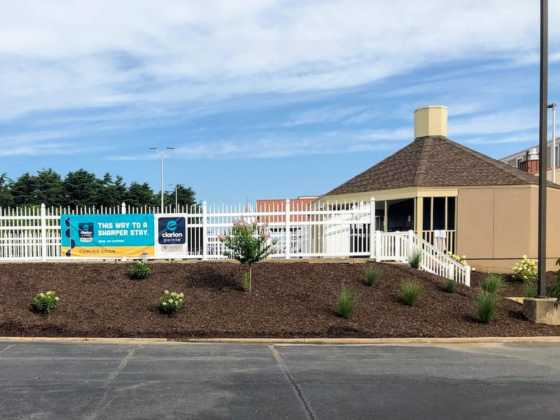 a picture facing the outdoor pool of the clarion pointe harrisonburg showing the upgraded landscaping and a coming soon sign for the clarion pointe harrisonburg