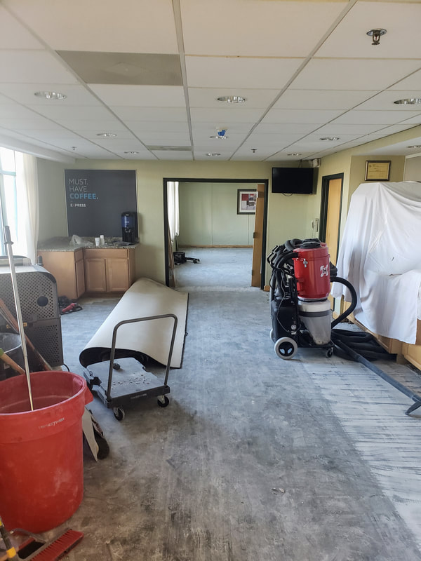 Picture of the renovations at the Holiday Inn Express & Suites Ocean City showing the breakfast area and great room with the old tile and carpet removed