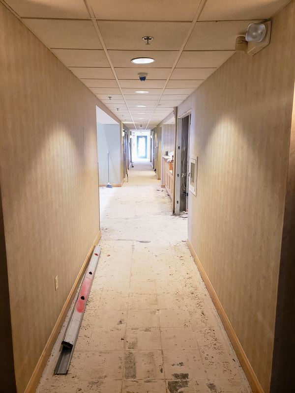 Picture of the renovations at the Holiday Inn Express & Suites Ocean City showing the main hallway on the lobby level with the old tile flooring removed